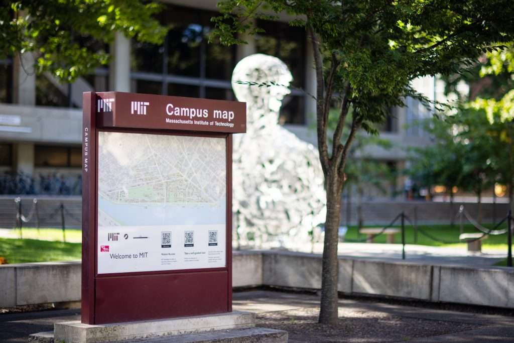 A campus map is featured at MIT in front of a statue filled with numbers.