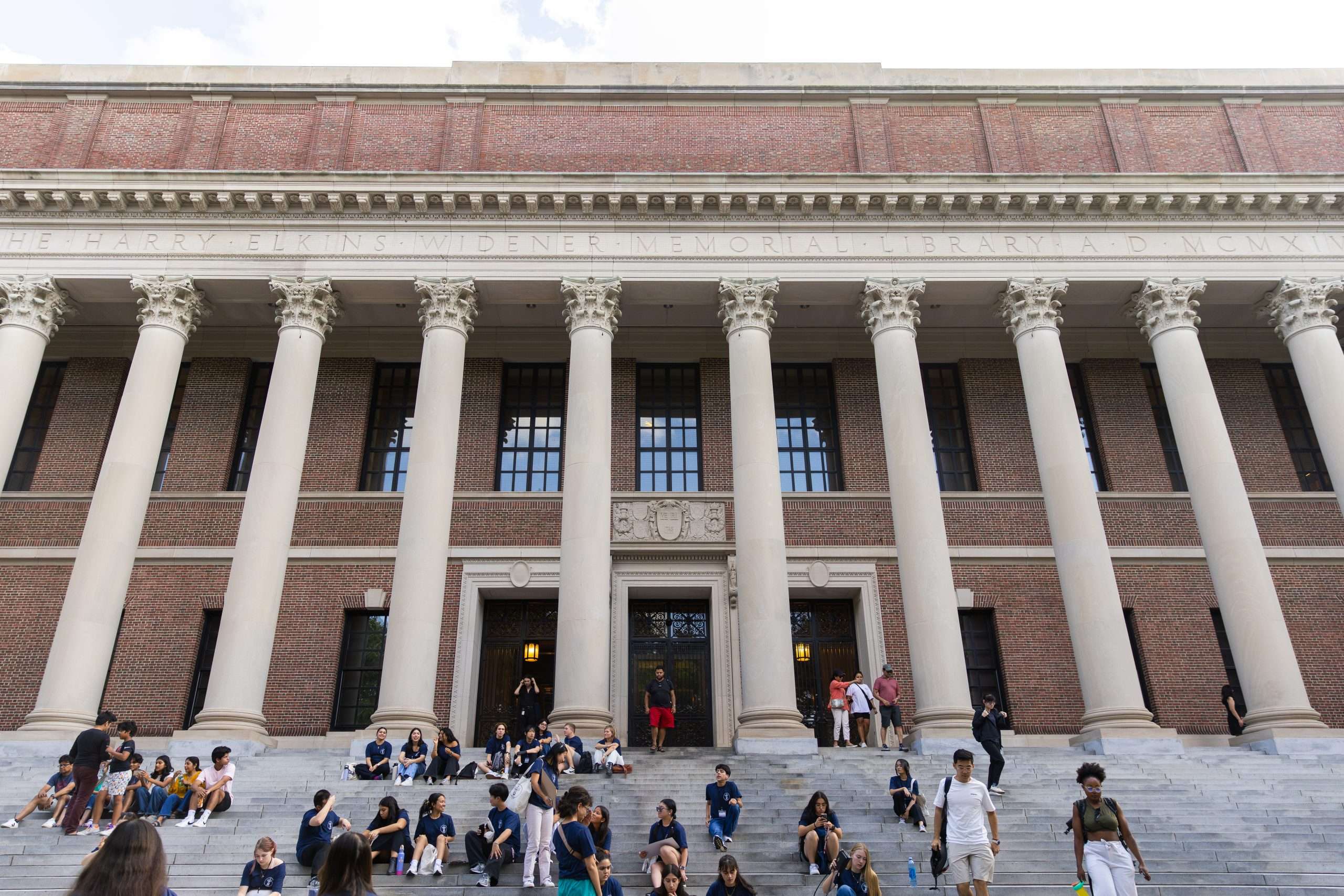 Students sit on the steps of Widener Library at Harvard University.