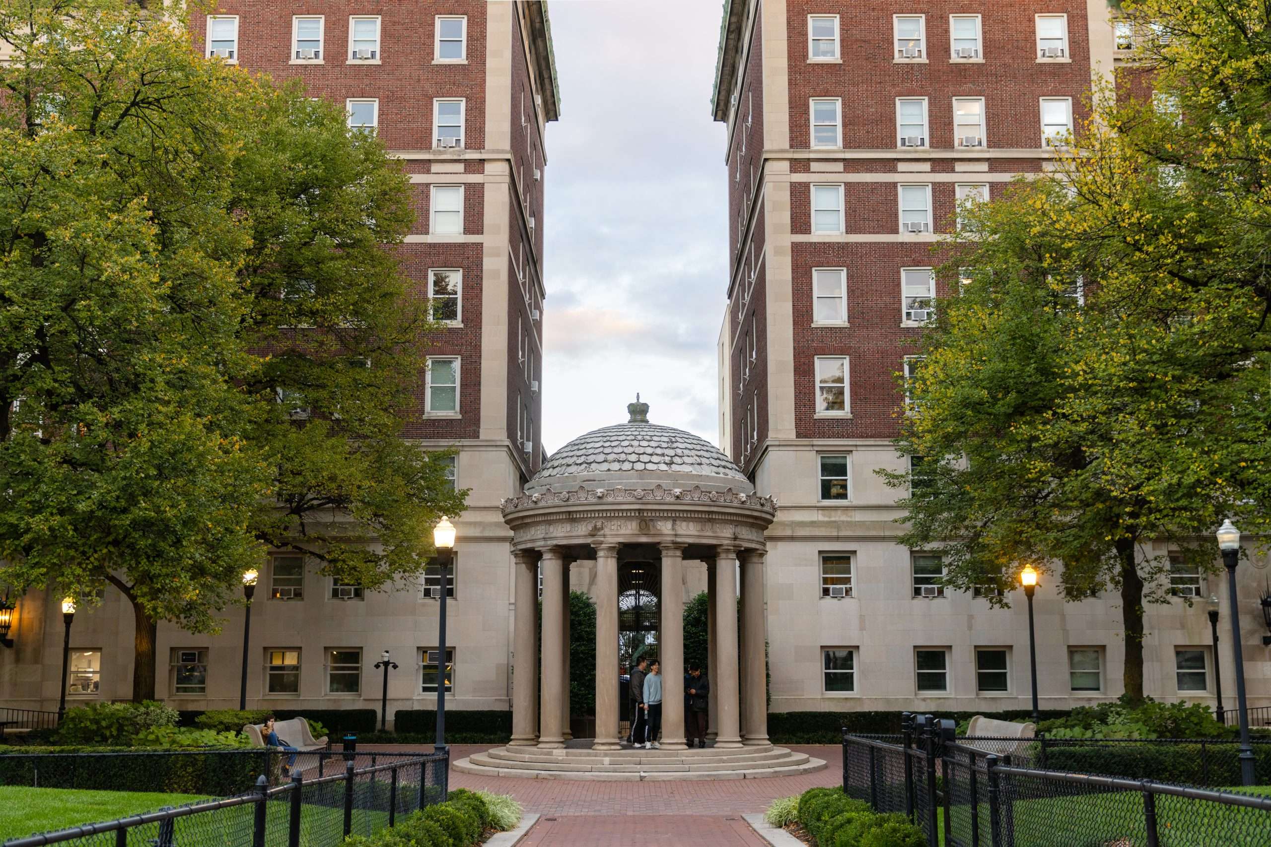 A rotunda connects two brick buildings at Columbia University.