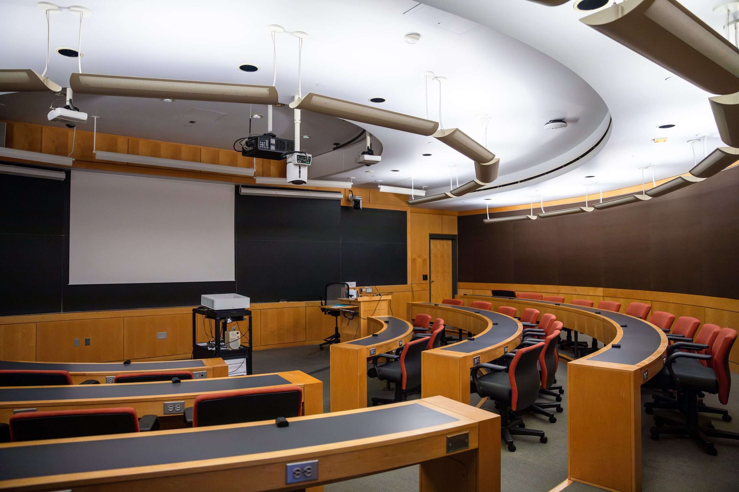 A wood-paneled classroom is featured at Harvard University.