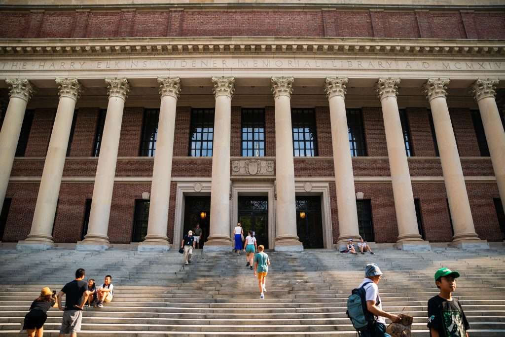 Students walk up the Widener Memorial Library steps at Harvard University.