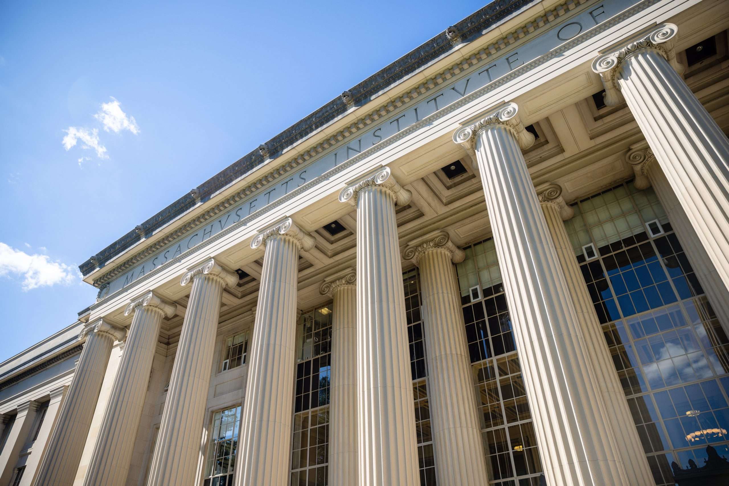 A view of a columned building with the Massachusetts Institute of Technology inscribed at the top.