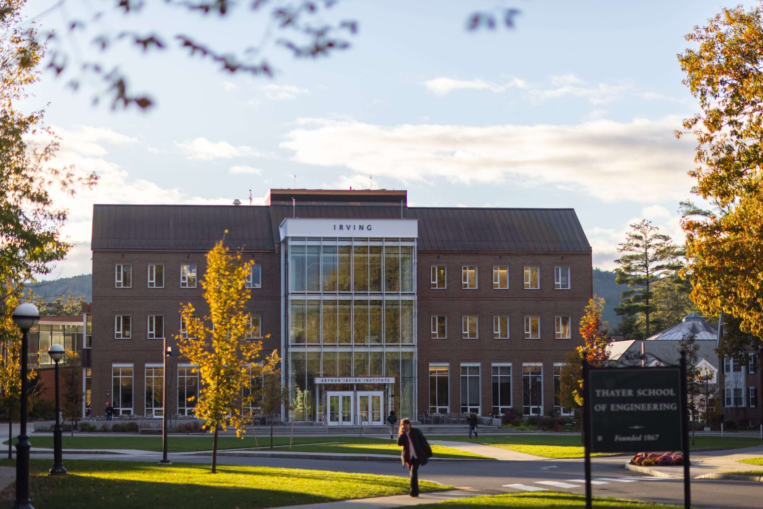 A student walks in front of the Irving Institute building at Dartmouth College.