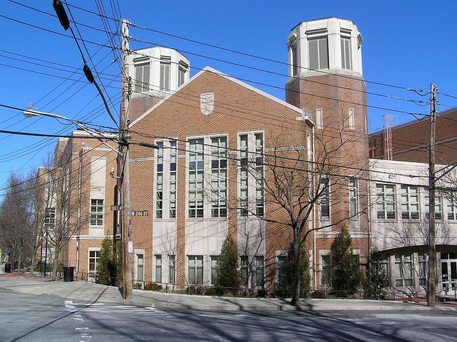 Telephone lines are strung up in front of a Horace Mann School facility.