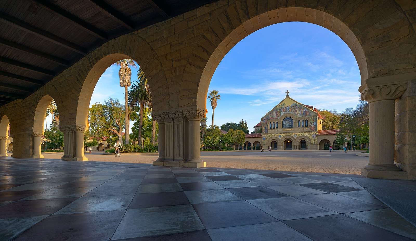 A view of Stanford University's campus from beneath an arch.