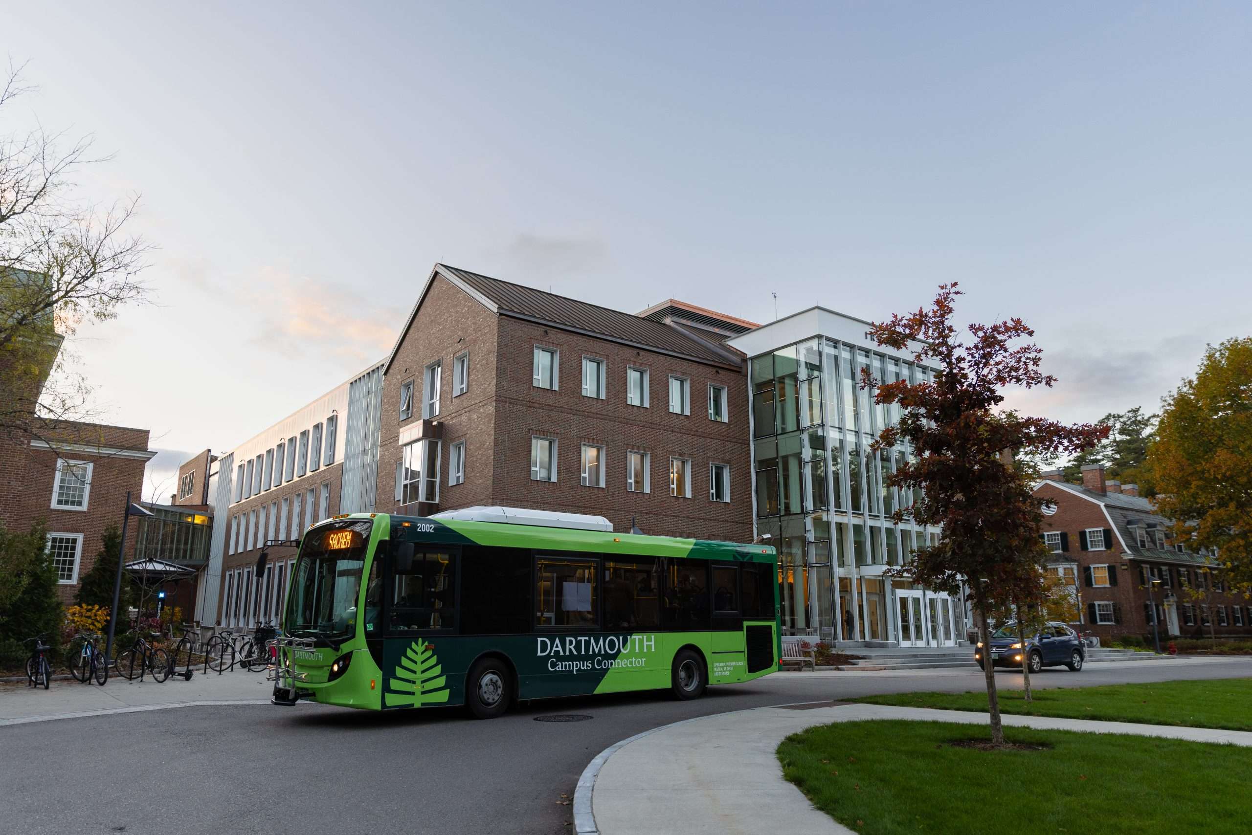 A Dartmouth bus is parked on a bend on Dartmouth's campus.
