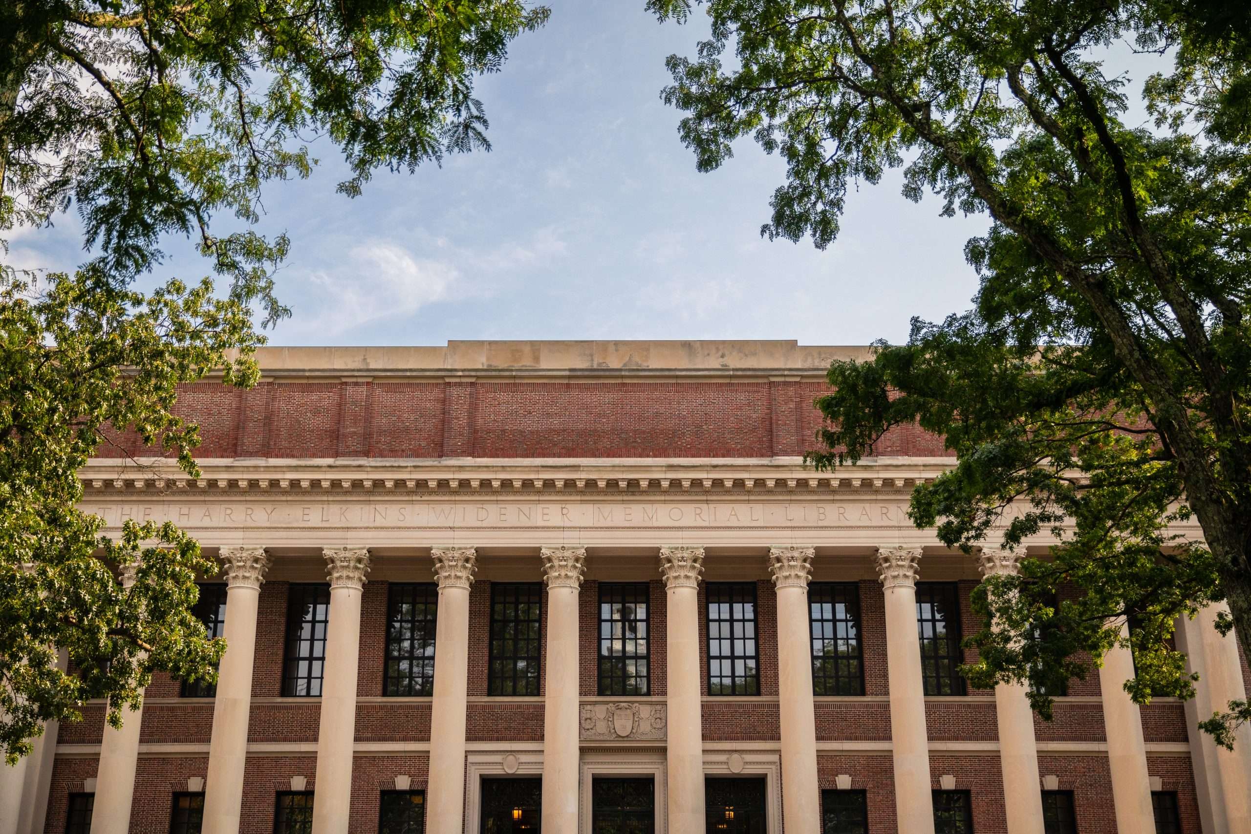 The exterior of a columned building is featured at Harvard University.