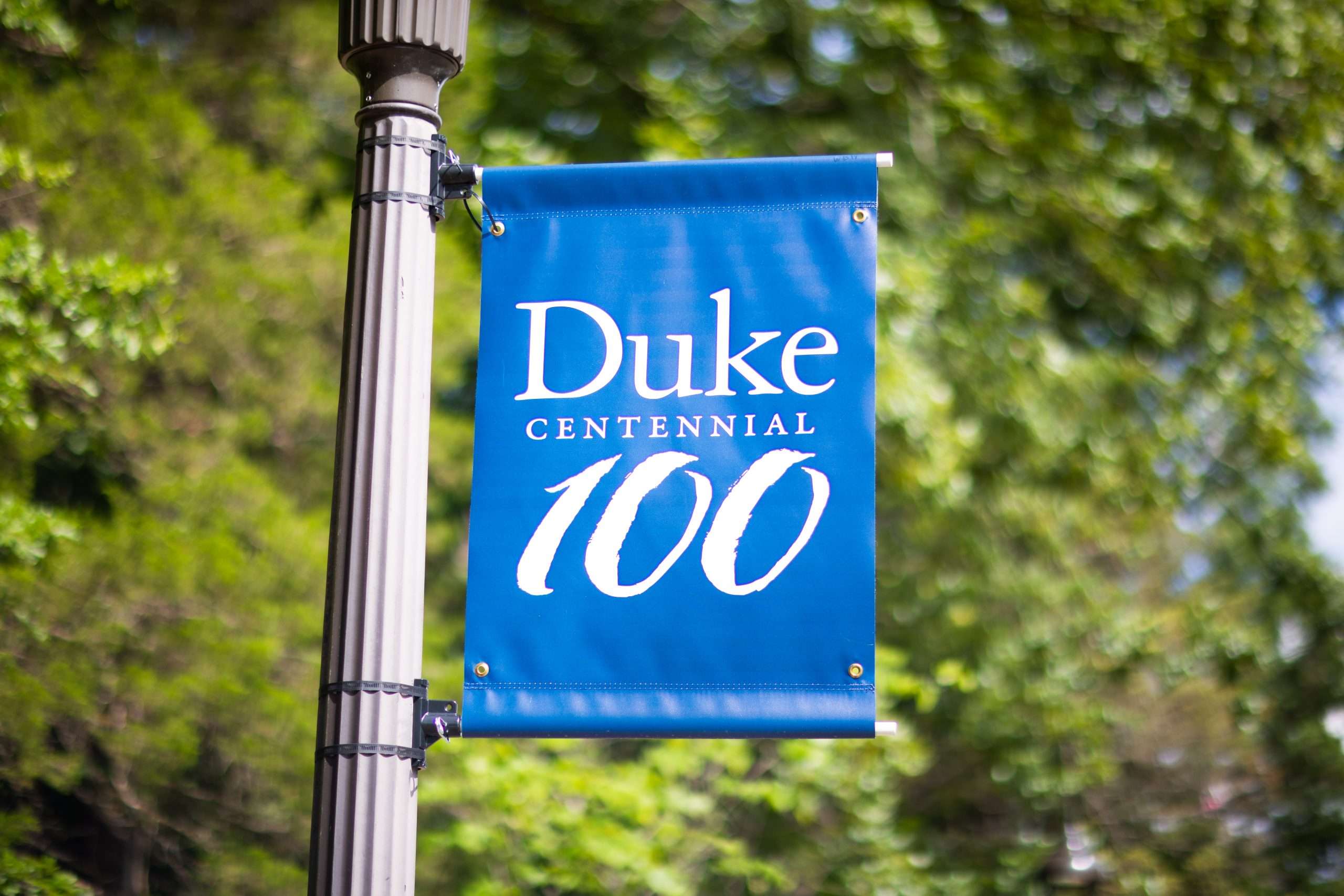A blue flag flies on a pole at Duke University commemorating the school's centennial anniversary.