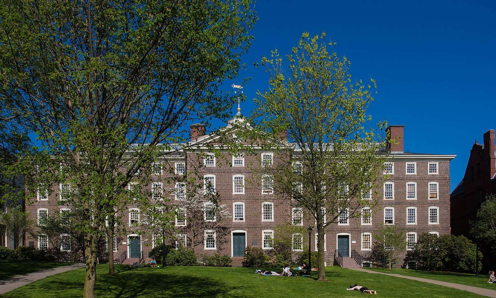 A brick building is featured beyond a lawn at Brown University.