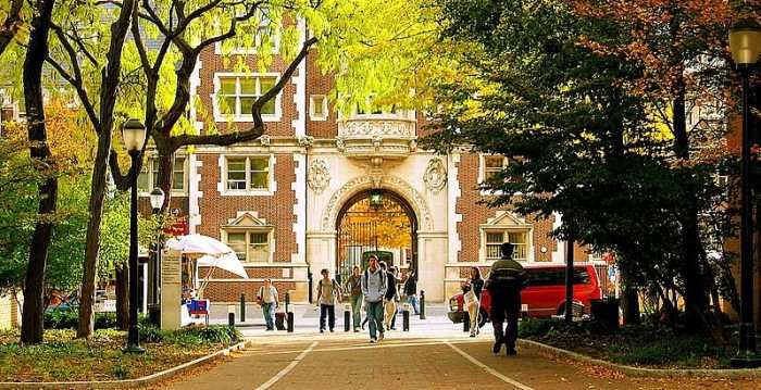 Students walk under the arch at the University of Pennsylvania.