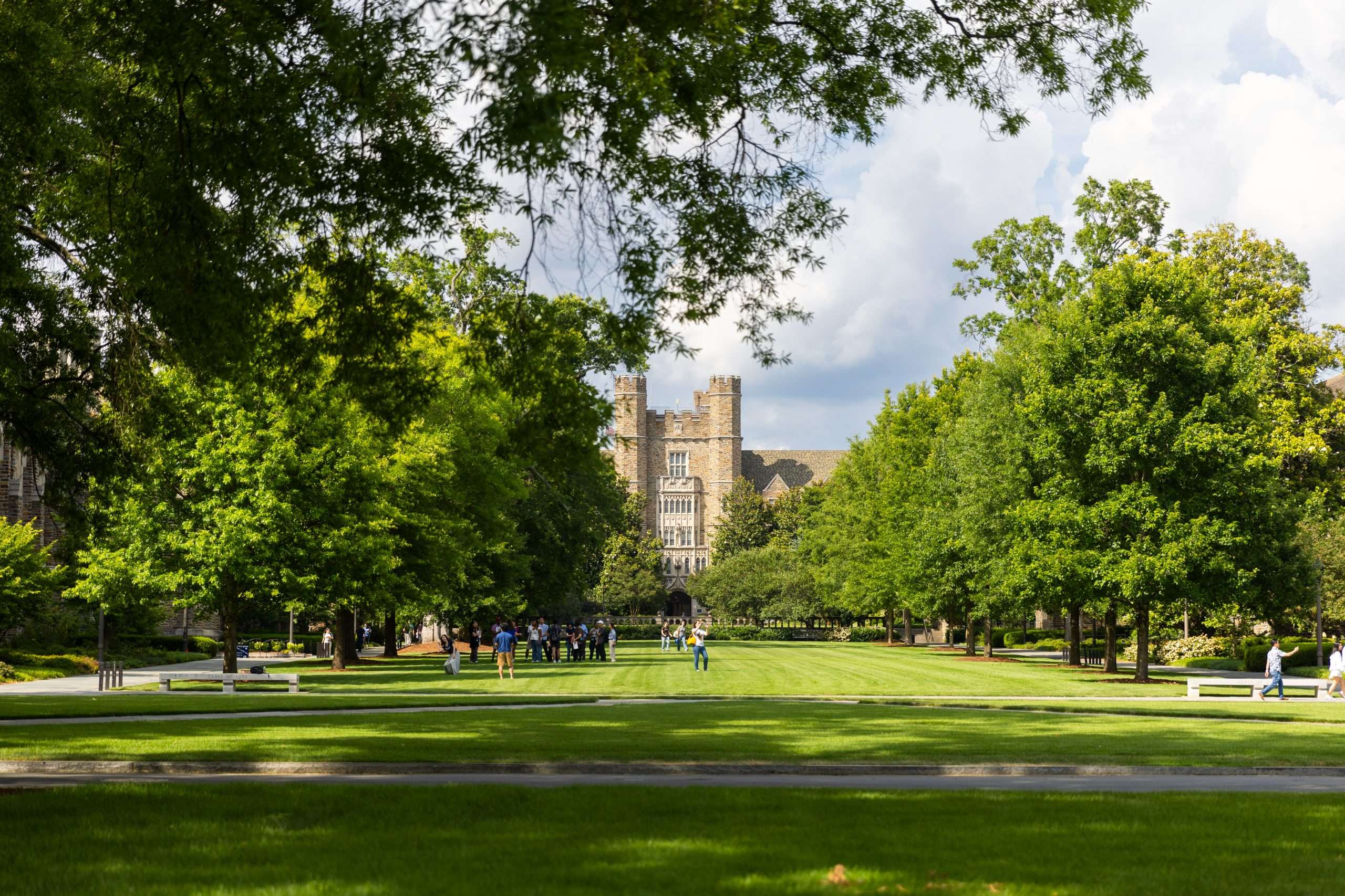 People gather on a freshly cut lawn in front of Duke Chapel at Duke University.